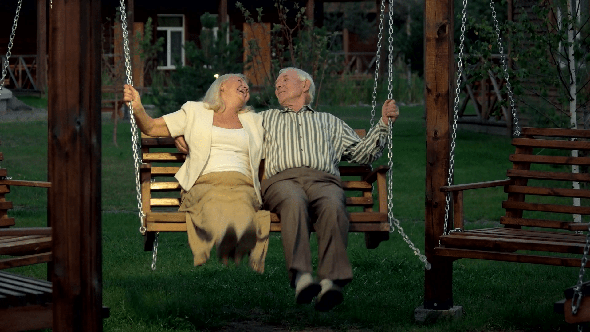 videoblocks-senior-couple-on-porch-swing-man-and-woman-outdoor-evening_srzymsyzz_thumbnail-full01.png